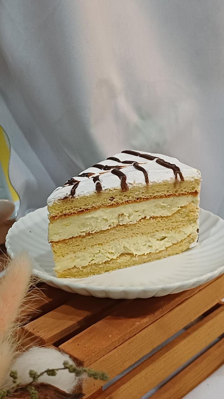 D24 Durian Cake slice showing multi-layer sponge with creamy filling and chocolate drizzle