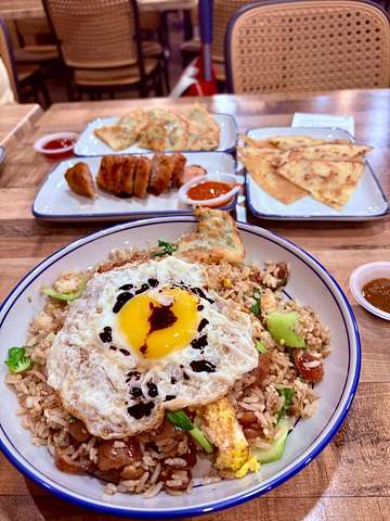 Fried rice with sunny-side-up egg and several shared dishes at Uncle Soon Plus Kitchen House