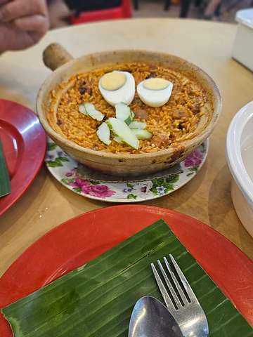 Claypot-style spiced rice dish with cucumber and boiled egg at Restaurant Unlimited SS14