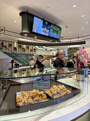 Inside Chongdee Teahouse with customers queuing
