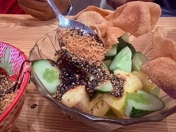 Fresh fruit salad with cucumber, pineapple, and crunchy topping at Bibi's Popiah