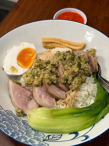 Sliced meat with herb sauce, soft-boiled egg, rice, and bok choy at Ming Kee Cantonese Taipan