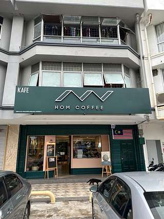 HOM Coffee storefront at Taman Subang Permai, USJ 1 — dark green signboard with white lettering above a glass entrance
