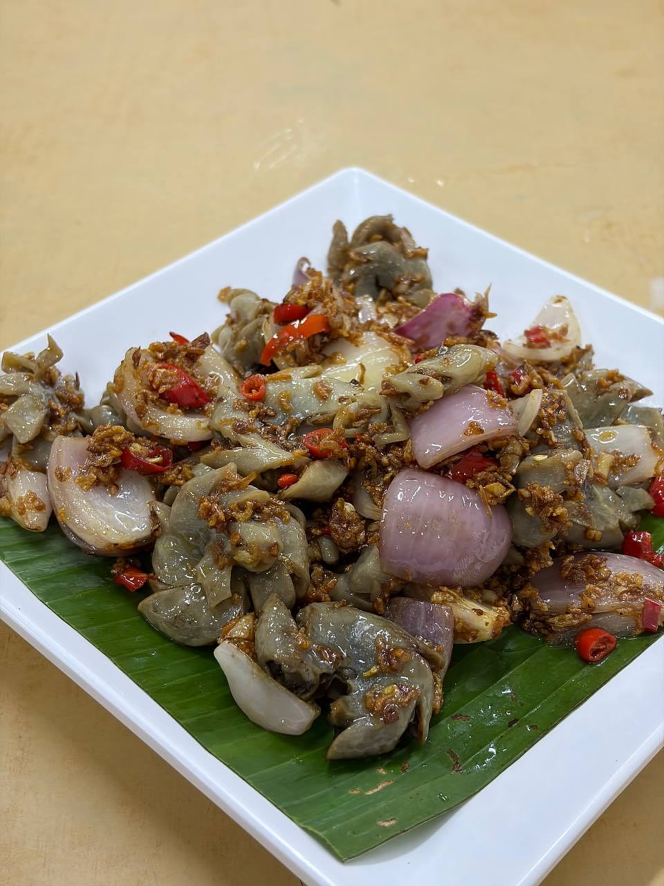 Seafood and mushroom dish served on banana leaf